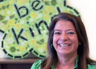 Helen Gomez smiling in front of the Ben’s Bells logo.